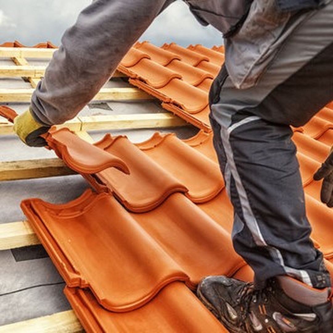Roofer at work, installing clay roof tiles, Germany fitness 12-1080